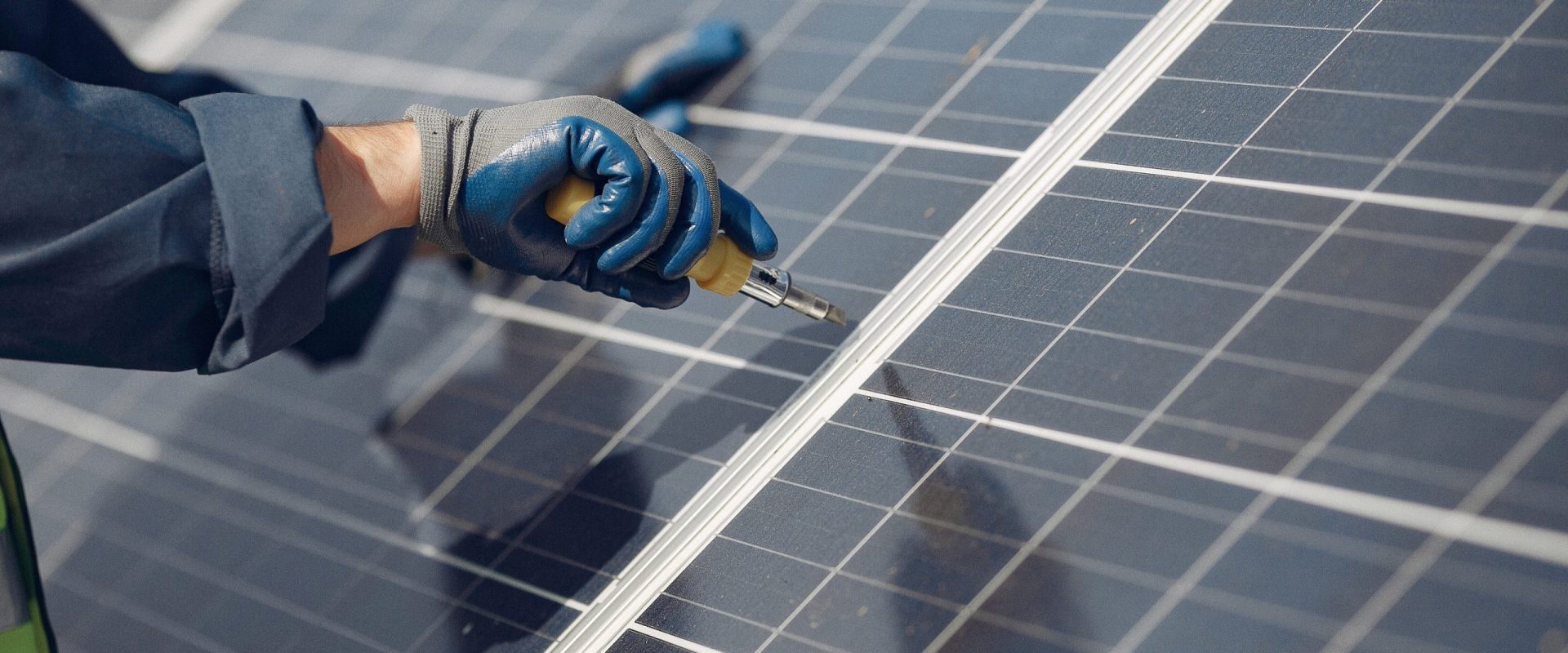 Engineer in a white helmet. Man near solar panel.